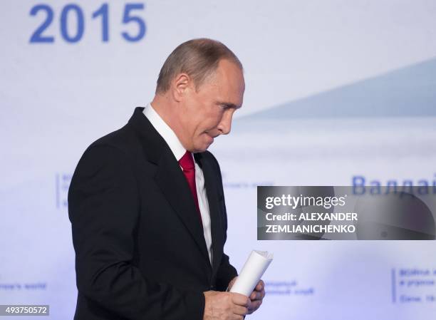 Russian President Vladimir Putin leaves the podium after delivering a speech during a meeting of members of the Valdai International Discussion Club...