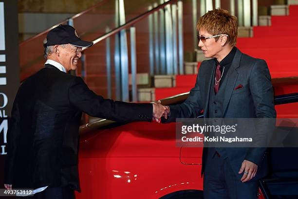 Director Yoshiyuki Tomino and Singer GACKT shake hands during the opening ceremony of the Tokyo International Film Festival 2015 at Roppongi Hills on...