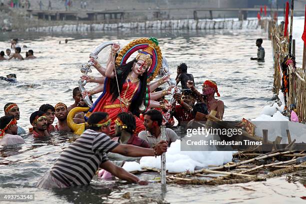 Devotees immersing idol of Goddess Durga in river Yamuna at Okhla Barrage on the occasion of Dashmi on October 22, 2015 in New Delhi, India. Puja...