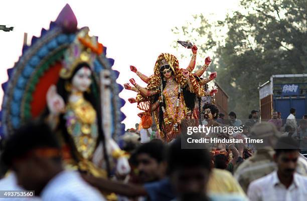 Devotees taking idol of Goddess Durga for immersion at river Yamuna near Okhla Barrage on the occasion of Dashmi on October 22, 2015 in New Delhi,...