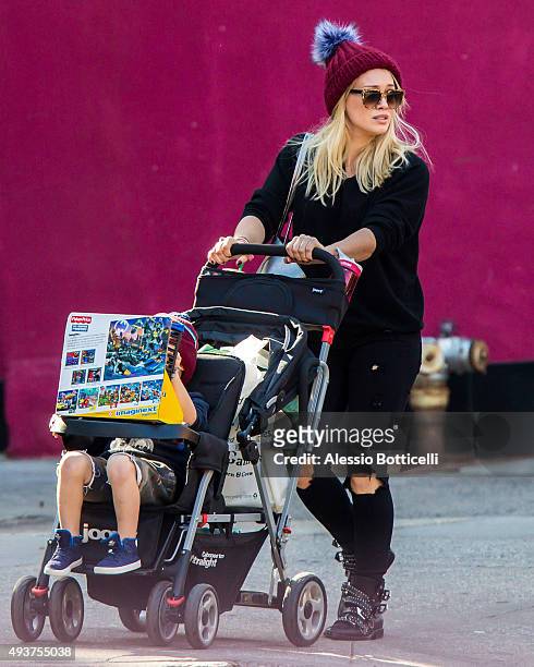 Hilary Duff is seen taking her son Luca Cruz Comrie to a toy shop on October 21, 2015 in New York City.