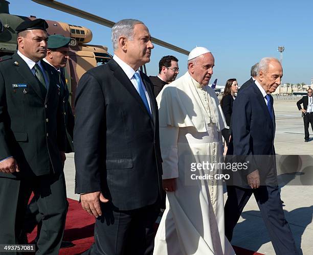In this handout provided by the Israeli Government Press Office , Pope Francis walks with Israel President Shimon Peres and Prime Minister of Israel...
