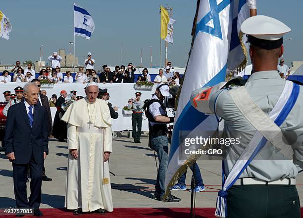 In this handout provided by the Israeli Government Press Office , Pope Francis stands with Israel President Shimon Peres during a welcoming cermony...