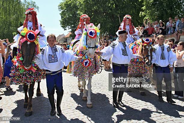 Eleven-year-old Frantisek Soban dressed as a girl and with a rose in his mouth leads the royal procession during Ride of the Kings in Vlcnov, south...