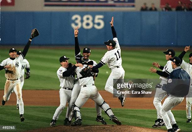 The New York Yankees celebrate on the field after winning the World Series Game four against the Atlanta Braves at Yankee Stadium in the Bronx, New...