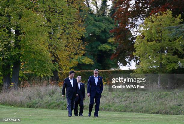 British Prime Minister David Cameron welcomes Chinese President Xi Jinping and an interpreter to his official residence at Chequers on October 22,...