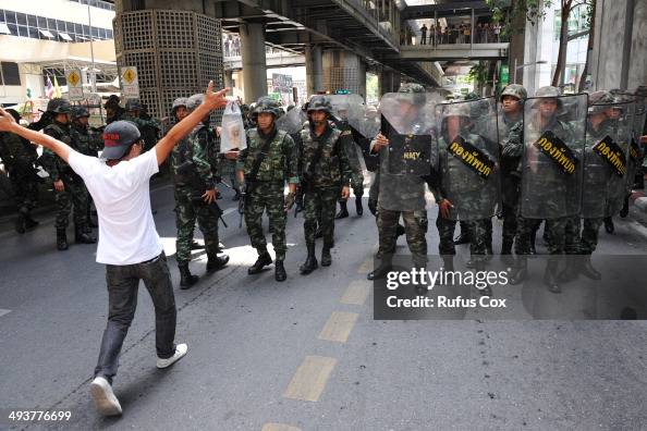 A protester confronts soldiers in riot gear during a city centre ...