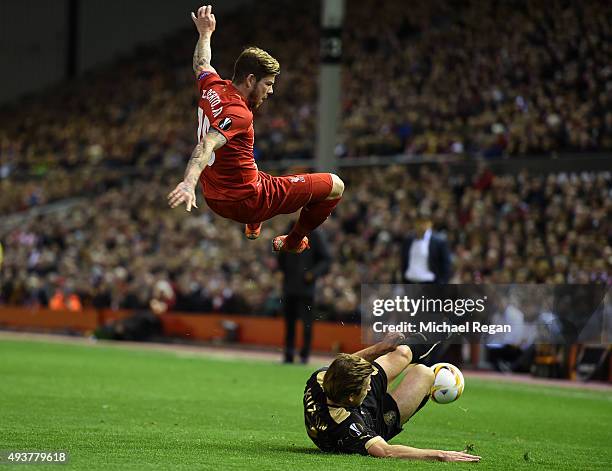 Alberto Moreno of Liverpool is tackled by Oleg Kuzmin of Rubin Kazan during the UEFA Europa League Group B match between Liverpool FC and Rubin Kazan...