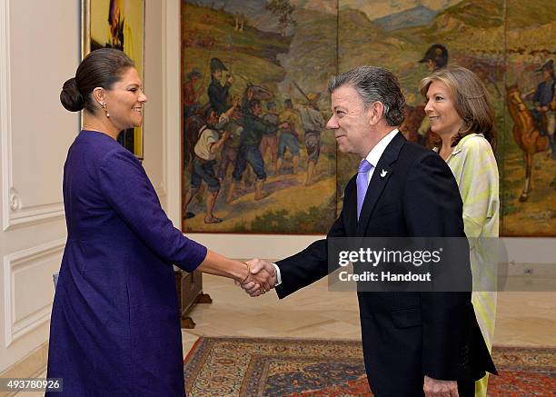 In this handout picture released by Presidencia de la Republica de Colombia, President of Colombia Juan Manuel Santos greets Crown Princess Victoria...