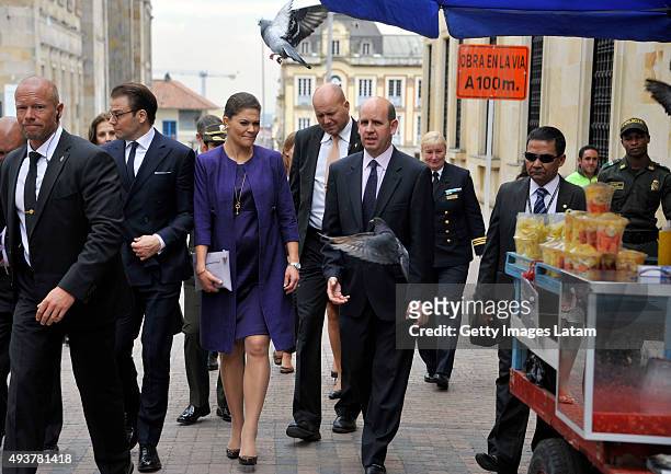 Crown Princess Victoria of Sweden and Prince Daniel of Sweden walk down a street of downtown Bogota after holding a private meeting with Colombia's...