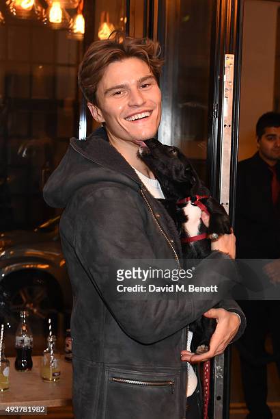 Oliver Cheshire and Huxley The Dog attend Whistles Men 1st birthday celebrations at Protein Galleries on October 22, 2015 in London, England.