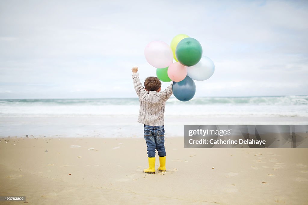 A 3 years old boy playing on the beach
