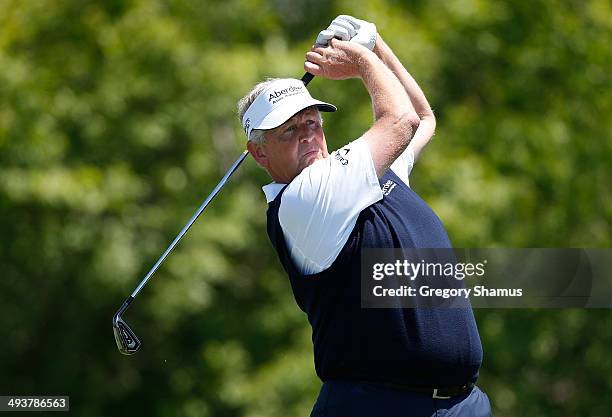 Colin Montgomerie of Scotland watches his tee shot on the fourth hole during the final round of the 2014 Senior PGA Championship presented by...