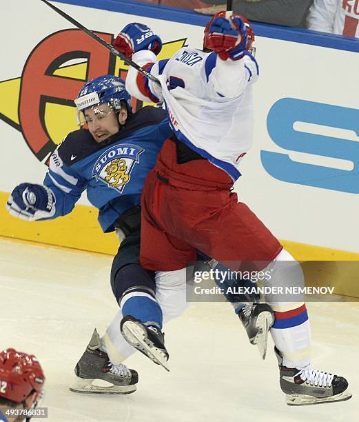 Russia's defender Denis Denisov vies with Finland's forward Pekka Jormakka during a gold medal game Russia vs Finland of the IIHF International Ice...