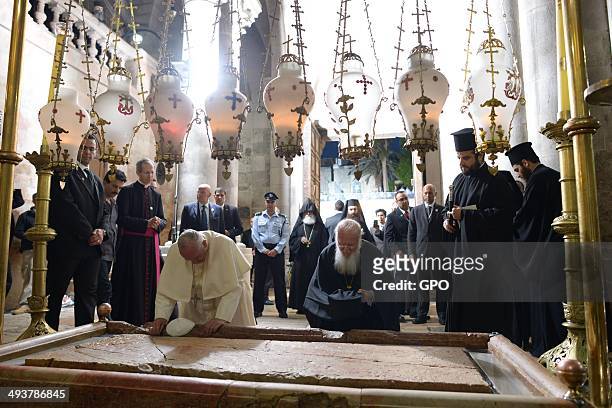In this handout provided by the Israeli Government Press Office , Pope Francis worships at the Stone of Anointing at the Church of the Holy Sepulchre...