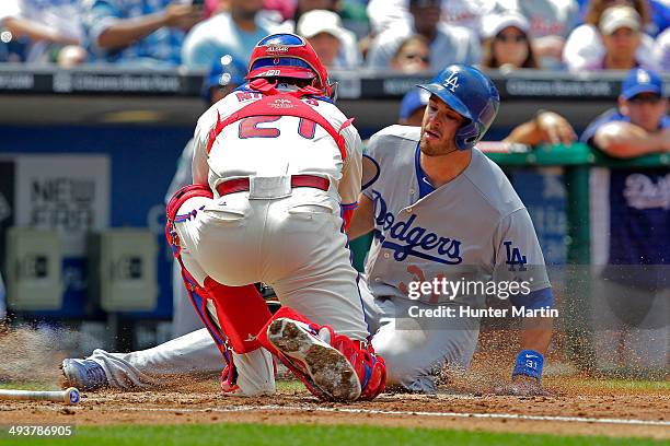 Drew Butera of the Los Angeles Dodgers slides into home as Wil Nieves of the Philadelphia Phillies tags him out in the second inning during a game...