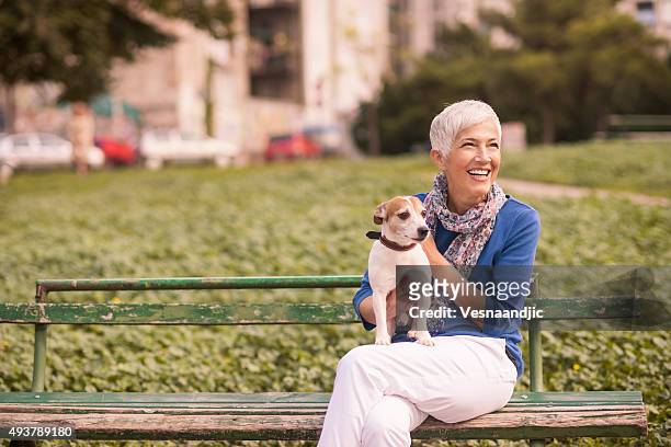 woman with dog at the cafe - woman dog bench stock pictures, royalty-free photos & images