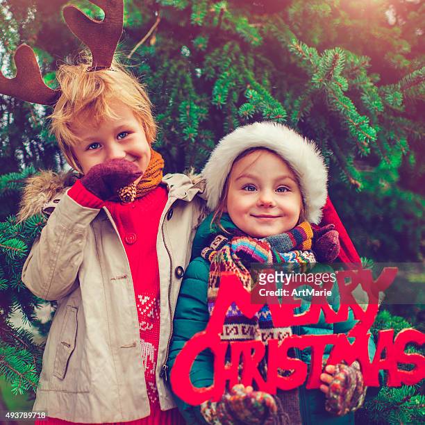 little girl and boy in xmas - small placard stock pictures, royalty-free photos & images
