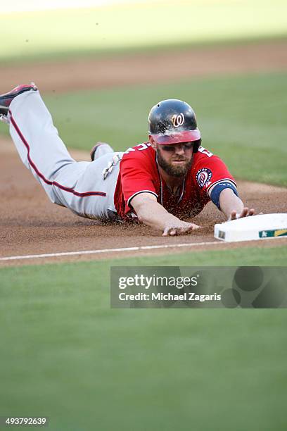 Kevin Frandsen of the Washington Nationals slides safely into third during the game against the Oakland Athletics at O.co Coliseum on May 10, 2014 in...