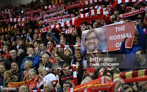 Liverpool fans hold scarves and a banner depicting Liverpool's German manager Jurgen Klopp before a UEFA Europa League group B football match between...