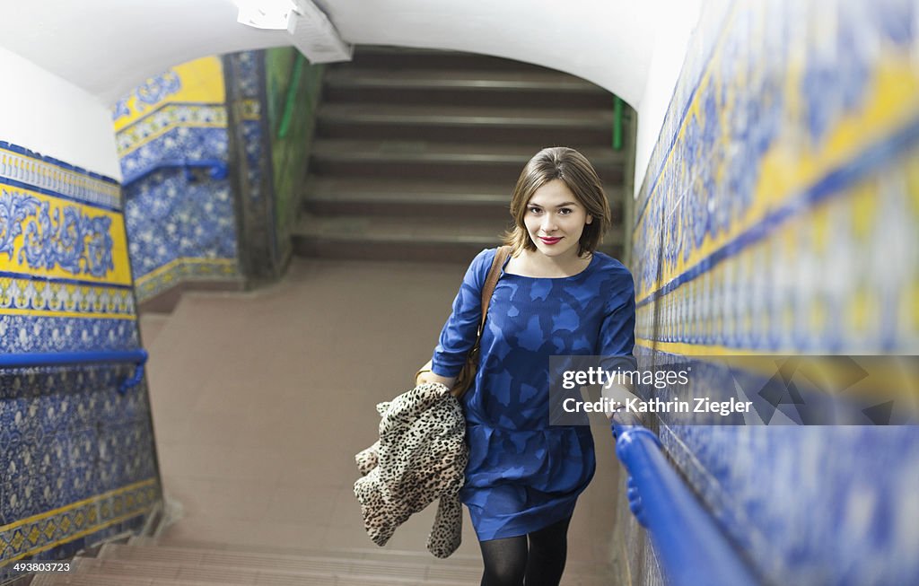 Young woman exiting beautiful subway station