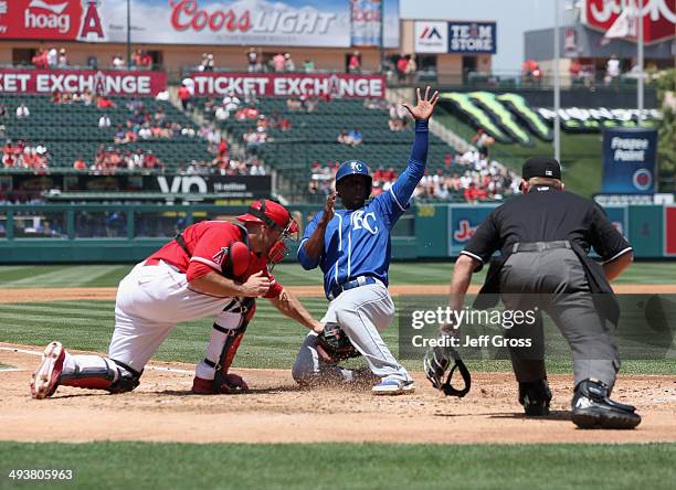 Pedro Ciriaco of the Kansas City Royals slides safely past the tag of catcher Chris Iannetta of the Los Angeles Angels of Anaheim and scores a run in...