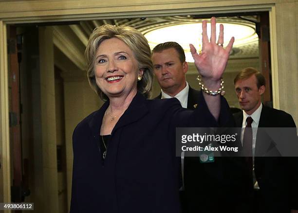 Democratic presidential candidate and former Secretary of State Hillary Clinton waves as she returns from a break for a hearing before the House...