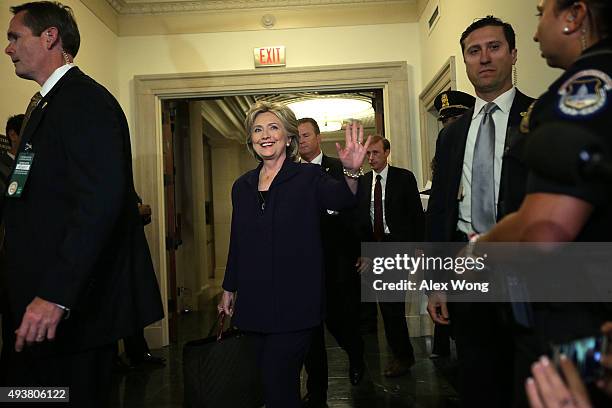 Democratic presidential candidate and former Secretary of State Hillary Clinton waves as she returns from a break for a hearing before the House...