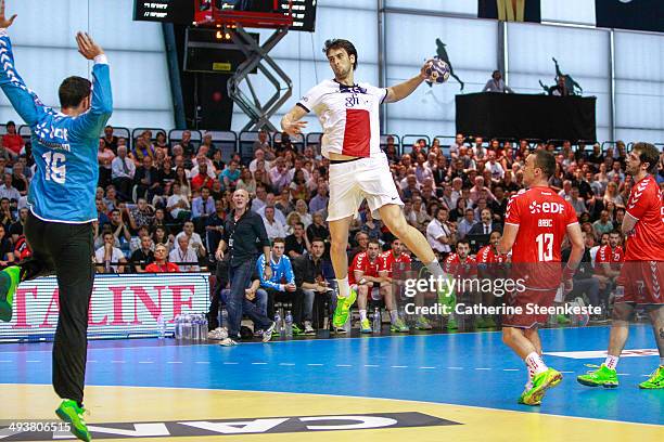 Marko Kopljar of Paris Handball shoots against Cyril Dumoulin of Chambery Savoie Handball during the men's final game of the French National Cup...