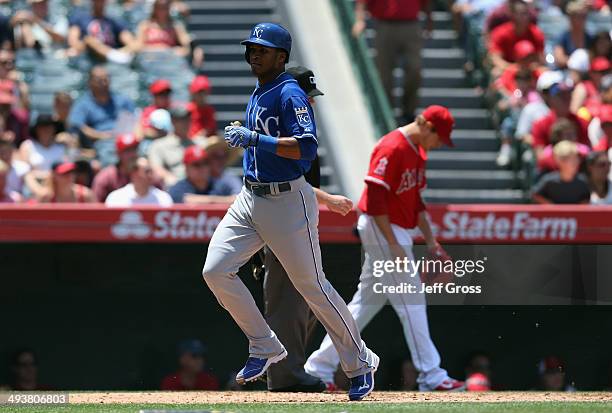Pedro Ciriaco of the Kansas City Royals scores a run, as pitcher Garrett Richards of the Los Angeles Angels of Anaheim looks down in the third inning...