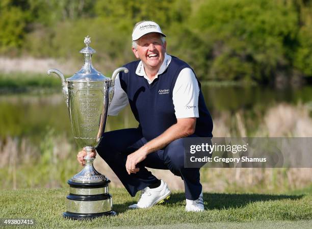 Colin Montgomerie of Scotland poses with the Alfred S. Bourne Trophy after winning the 2014 Senior PGA Championship presented by KitchenAid with a...