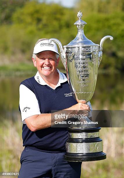 Colin Montgomerie of Scotland poses with the Alfred S. Bourne Trophy after winning the 2014 Senior PGA Championship presented by KitchenAid with a...