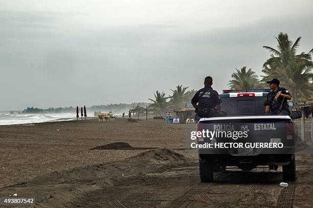 Police patrol the beach in Boca de Pascuales, Colima State, Mexico, on October 22, 2015. Fast-moving Patricia grew into an "extremely dangerous"...