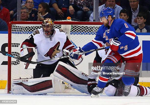 Kevin Klein of the New York Rangers attempts to deflect a shot by Ryan McDonagh against Mike Smith of the Arizona Coyotes at Madison Square Garden on...