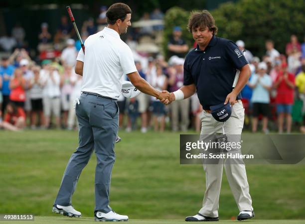 Adam Scott of Australia shakes hands with Jason Dufner after a birdie putt on the third playoff hole to defeat him and win the 18th hole during the...