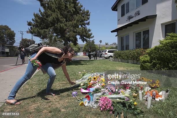 Woman places flowers on the lawn of the Alpha Phi sorority house May 25, 2014 in Isla Vista, California. According to reports, 22 year old Elliot...