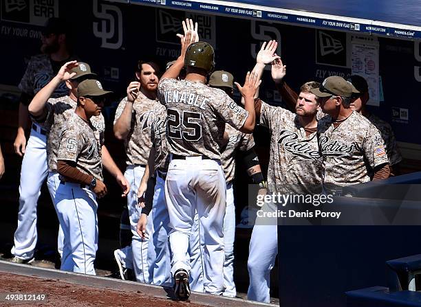 Will Venable of the San Diego Padres is congratulated after scoring during the sixth inning of a baseball game against the Chicago Cubs at Petco Park...