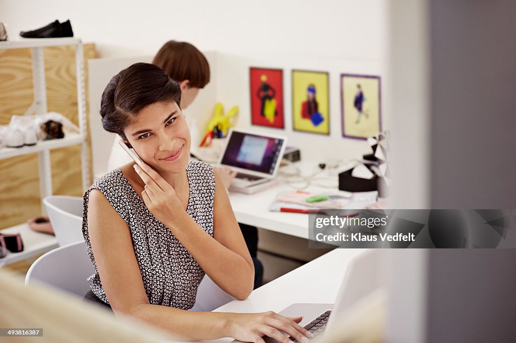 Creative businesswoman holding phone