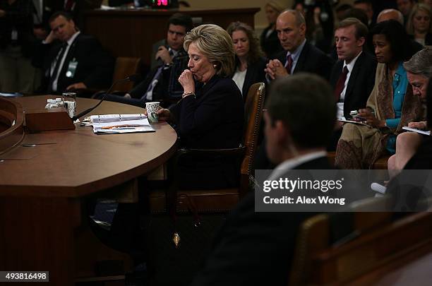 Democratic presidential candidate and former Secretary of State Hillary Clinton coughs during testimony that lasted more than 10 hours during a...