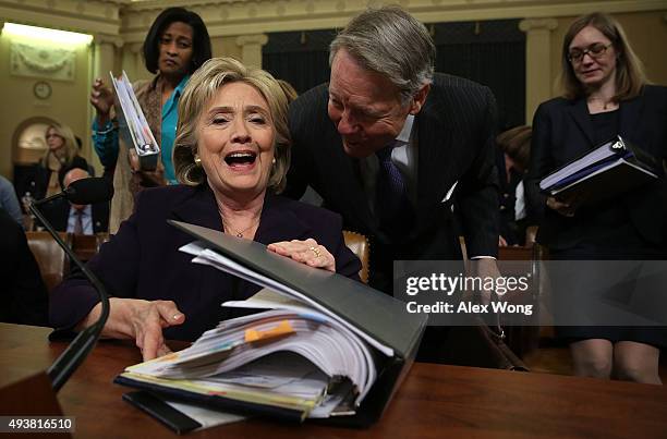 Democratic presidential candidate and former Secretary of State Hillary Clinton closes her binder after a hearing before the House Select Committee...