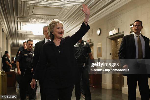 Democratic presidential candidate and former Secretary of State Hillary Clinton waves goodbye to journalists after testifying to the House Select...