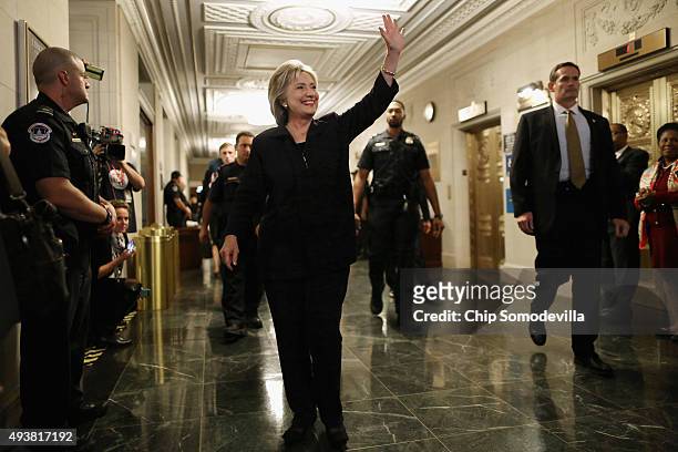 Democratic presidential candidate and former Secretary of State Hillary Clinton waves goodbye to journalists after testifying to the House Select...