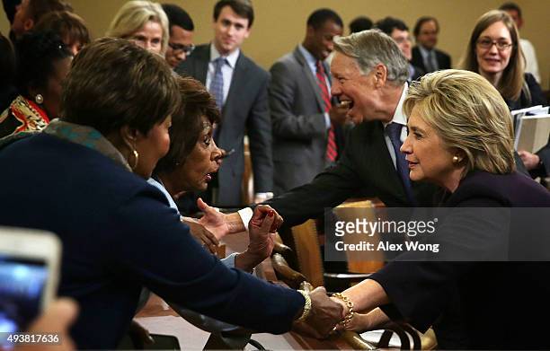 Democratic presidential candidate and former Secretary of State Hillary Clinton is greeted by Rep. Maxine Waters and other House Democrats after a...