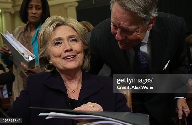 Democratic presidential candidate and former Secretary of State Hillary Clinton closes her binder after a hearing before the House Select Committee...