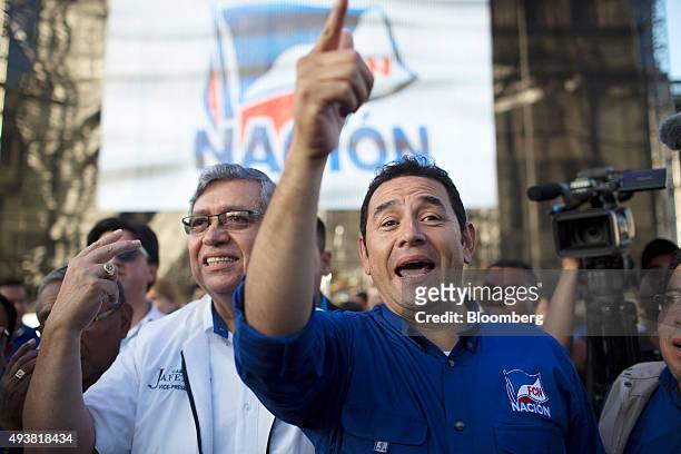 Presidential candidate Jimmy Morales, right, gestures as he arrives at a campaign rally in Guatemala City, Guatemala, on Thursday, Oct. 22, 2015....