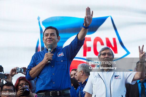 Presidential candidate Jimmy Morales, left, waves at a campaign rally in Guatemala City, Guatemala, on Thursday, Oct. 22, 2015. Morales, an actor and...