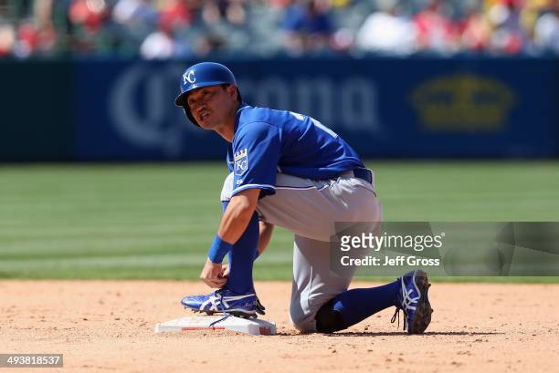 Norichika Aoki of the Kansas City Royals ties his shoe at second base after coming into the game against the Los Angeles Angels of Anaheim as a pinch...