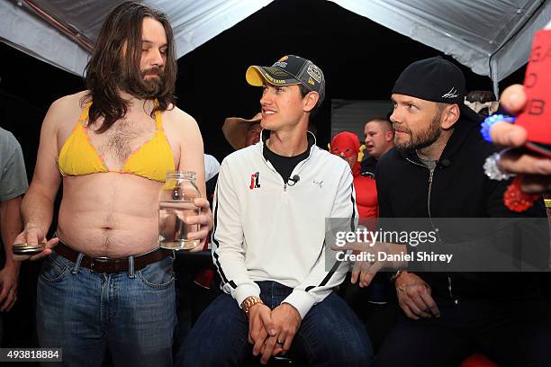 Joey Logano, driver of the Shell Penzoil Ford, participates in the filming of an episode of E's "The Soup" with TV personality Joel McHale and...