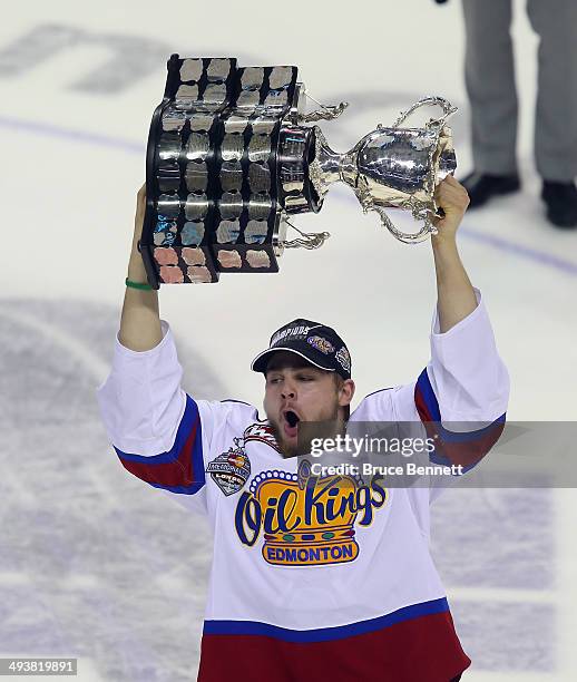 Aaron Irving of the Edmonton Oil Kings skates with the Memorial Cup trophy following a 6-3 victory over the Guelph Storm in the 2014 Memorial Cup...