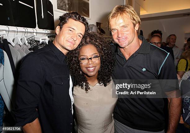 Actor Orlando Bloom, Orpah Winfrey, and professional surfer Laird Hamilton attend the launch of Laird Apparel by Laird Hamilton at Ron Robinson on...